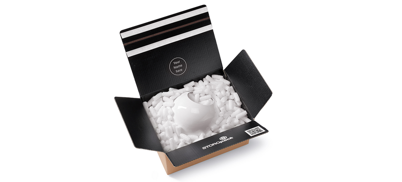 Una caja de cartón que contiene una cafetera y chips de embalaje orgánicos alargados